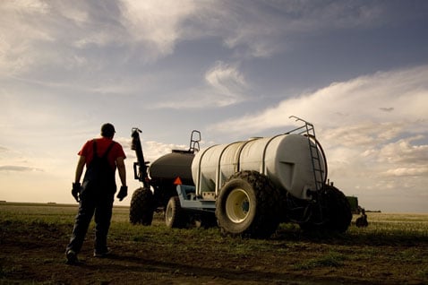 Man with seeder in field